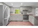 Well-appointed kitchen featuring stainless steel appliances, granite countertops, and ample cabinet space at 6121 Kelvin Dr, Durham, NC 27712