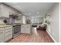 This eat-in kitchen features modern appliances, granite countertops, and hardwood floors, perfect for entertaining guests at 6121 Kelvin Dr, Durham, NC 27712