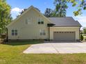 Rear view of house, showing garage and door to backyard at 6907 Field Hill Rd, Raleigh, NC 27603