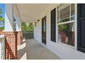 Welcoming covered porch with brick pillars and a decorative front door at 72 Cokesbury Park Ln, Fuquay Varina, NC 27526