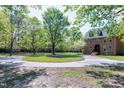 Spacious lawn surrounds this two-story brick home with mature landscaping at 8120 Stillbreeze Dr, Fuquay Varina, NC 27526
