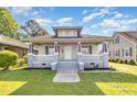 Charming two-story home featuring a welcoming front porch, fresh paint, and a well-maintained lawn at 813 S Franklin St, Rocky Mount, NC 27803