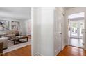 Hallway leading to a spacious living room with hardwood floors and bright natural light at 904 Emory Ln, Raleigh, NC 27609