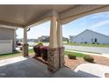 Inviting front porch with brick pillars and a view of the neighborhood street at 1007 Fairhaven Dr, Mebane, NC 27302