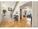Elegant foyer with hardwood floors, staircase, and views into the living spaces at 1009 Linenhall Way, Wake Forest, NC 27587