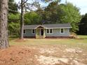 Exterior view of a house featuring light blue siding, a dark door, and small new wooden decks at 1165 John Mitchell Rd, Youngsville, NC 27596