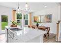 Kitchen island features stainless steel sink with gooseneck faucet at 1177 Tembrook Dr, Mebane, NC 27302