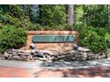 Innisfree community sign with brick and stone masonry work in a lush, wooded setting at 12 Innisfree Dr, Durham, NC 27707