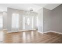 Open living room featuring hardwood flooring and abundant natural light throughout the space at 1301 Tawny View Ln, Raleigh, NC 27603