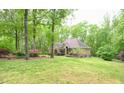 Beautiful brick home with mature trees and greenery offering a sense of privacy and tranquility at 14 Whit Ct, Angier, NC 27501