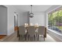 Elegant dining room featuring a modern chandelier and a bright window at 157 Celeste Cir, Chapel Hill, NC 27517