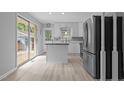 Modern kitchen featuring stainless steel appliances, an island, and sliding glass doors at 157 Celeste Cir, Chapel Hill, NC 27517