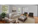 Bright living room with neutral colors, a large window, and hardwood floors at 157 Celeste Cir, Chapel Hill, NC 27517