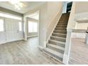 Inviting foyer with wood-look floors and a staircase leading to the upper level at 186 Gumtop Dr, Zebulon, NC 27597