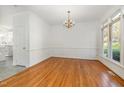 Bright dining room with hardwood floors, chandelier, and large window offering lots of natural light at 201 Langston Mill Ct, Cary, NC 27518