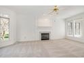 Inviting living room featuring a fireplace with marble hearth and large windows for ample natural light at 201 Langston Mill Ct, Cary, NC 27518