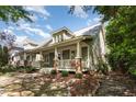 Charming home boasts a spacious front porch, complemented by lush landscaping and serene surroundings at 2106 Cloud Cover Ln, Raleigh, NC 27614