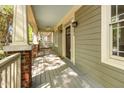 Spacious front porch featuring brick accents, providing a welcoming entrance to the home at 2106 Cloud Cover Ln, Raleigh, NC 27614