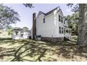 Side view of the home highlighting the well-kept lawn and detached garage at 2122 Pleasant Hill Rd, Rocky Mount, NC 27801