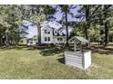 Picturesque exterior with lush greenery, a private well and a charming cottage-style home at 2122 Pleasant Hill Rd, Rocky Mount, NC 27801