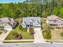 Aerial view of a charming home with a well-kept lawn, and a two car garage in a neighborhood at 215 Terrell Dr, Rolesville, NC 27571