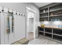 Mudroom features built-in shelving, coat hooks, bench, and wood-look floors at 238 W Paige Wynd Dr, Angier, NC 27501