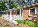 Charming exterior view showcasing a front porch, brick accents, and well-maintained landscaping, enhancing curb appeal at 2506 N Duke St, Durham, NC 27704