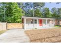 Charming home with a bright red door, inviting front porch and a charming wooden fence at 2506 N Duke St, Durham, NC 27704