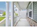 Spacious covered front porch with white pillars and railings, offering a relaxing outdoor space at 2749 Nettles Ridge Way, Fuquay Varina, NC 27526