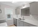 Bright kitchen with stainless steel appliances, gray cabinets, and quartz countertops at 2806 Shaftsbury St, Durham, NC 27704