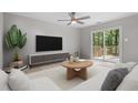 Bright living room features ceiling fan, decorative rug, and sliding glass door to deck at 2806 Shaftsbury St, Durham, NC 27704
