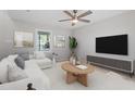 Light-filled living room showcasing modern decor, a ceiling fan, and comfortable seating at 2806 Shaftsbury St, Durham, NC 27704