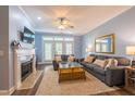 Comfortable living room with fireplace, plush seating, and French doors for bright, airy feel at 2810 Bedford Green Dr # 207, Raleigh, NC 27604