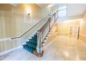 Elegant staircase with carpet runner and polished marble floors, offering a grand entrance to the building at 2810 Bedford Green Dr # 207, Raleigh, NC 27604