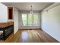 Bright dining room features wood floors, large windows, and a decorative light fixture at 301 Charleston Ln, Chapel Hill, NC 27517
