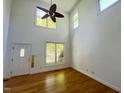 Bright living room with hardwood floors, a ceiling fan, and large windows at 301 Charleston Ln, Chapel Hill, NC 27517