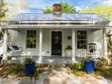 Charming cottage-style home with a welcoming porch and beautifully landscaped front yard at 310 N Hassel St, Hillsborough, NC 27278