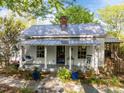 Charming cottage-style home with a welcoming porch, swing, and beautifully landscaped front yard at 310 N Hassel St, Hillsborough, NC 27278