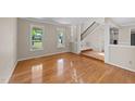Open living space with hardwood floors and stairs to the upper level in neutral color palette at 311 Arlington Rdg, Cary, NC 27513