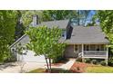 Charming home featuring an attached garage, front porch, and well-kept landscaping at 311 Arlington Ridge Rdg, Cary, NC 27513