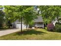 Lovely home with a well-manicured lawn, front porch, and mature trees at 311 Arlington Ridge Rdg, Cary, NC 27513