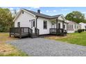 Charming home featuring a covered front porch with dark wood railings and steps at 326 W Gilbreath St, Graham, NC 27253