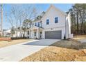 Beautiful two-story home featuring a modern design, long driveway, and attached garage at 3297 Oakfields Rd # 1, New Hill, NC 27562