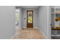Inviting entryway with hardwood floors and a glimpse of the bathroom at 3316 Milton Rd, Raleigh, NC 27609