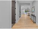 Bright hallway with hardwood floors leading to the living room at 3316 Milton Rd, Raleigh, NC 27609