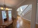 Welcoming entryway featuring hardwood floors, an elegant staircase, and an arched doorway leading to other rooms at 4103 Cheek Point Pl, Burlington, NC 27215