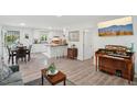 Inviting living room with ample natural light, open floorplan, and hardwood flooring at 423 Orange Heights Rd, Hillsborough, NC 27278