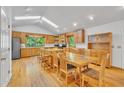 Eat-in kitchen with skylights, hardwood floors, stainless appliances, and custom wood cabinetry at 480 Big Branch Dr, Pittsboro, NC 27312