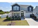 Beautiful two-story home with gray siding, a covered porch, a two car garage and a nicely landscaped front yard at 490 Mallard Loop Dr Dr, Clayton, NC 27527