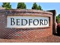 Brick sign at the entrance of the Bedford neighborhood, surrounded by lush greenery at 490 Mallard Loop Dr Dr, Clayton, NC 27527